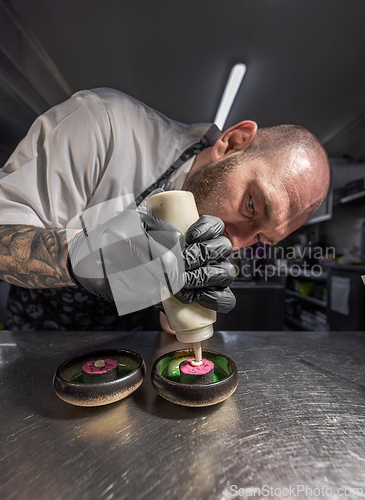 Image of Chef garnishing gourmet dishes