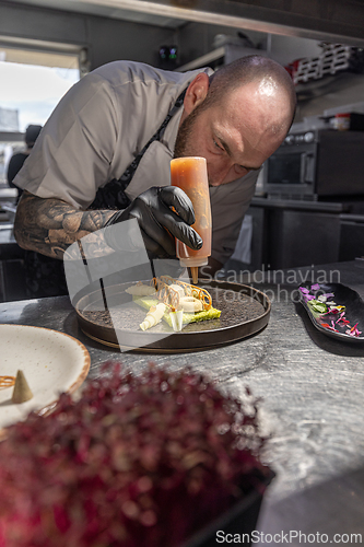 Image of Chef carefully adding finishing touchesProfessional chef careful