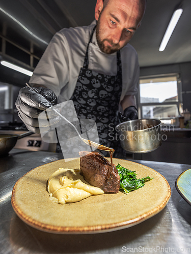 Image of Chef pouring sauce