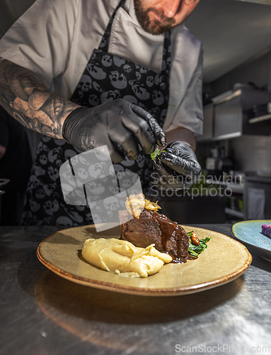Image of Professional chef adding final touch