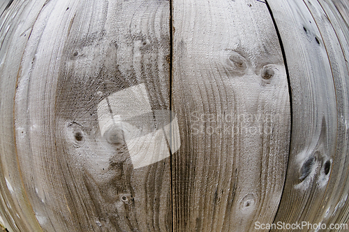 Image of Creative patterns formed in weathered wooden planks at an outdoo