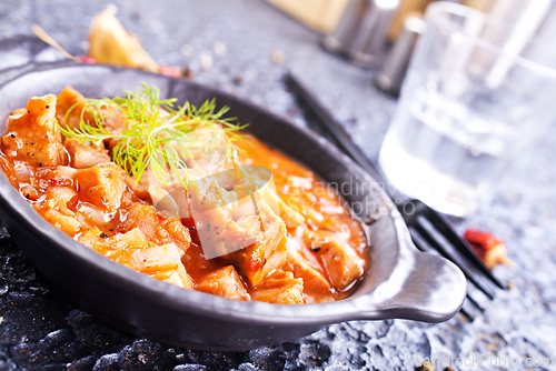 Image of fried meat with tomato sauce and vegetables