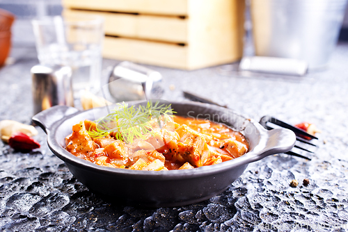 Image of fried meat with tomato sauce and vegetables