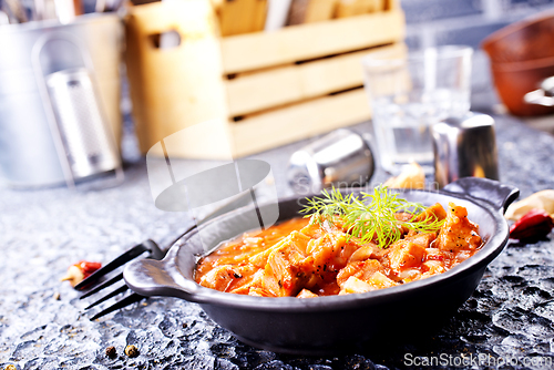 Image of fried meat with tomato sauce and vegetables