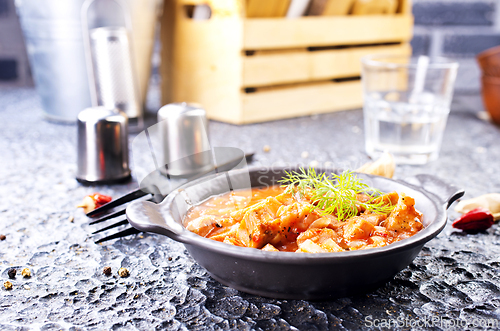 Image of fried meat with tomato sauce and vegetables
