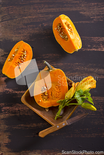 Image of fresh pumpkin on wooden table, raw pumpkin
