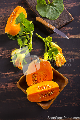 Image of fresh pumpkin on wooden table, raw pumpkin