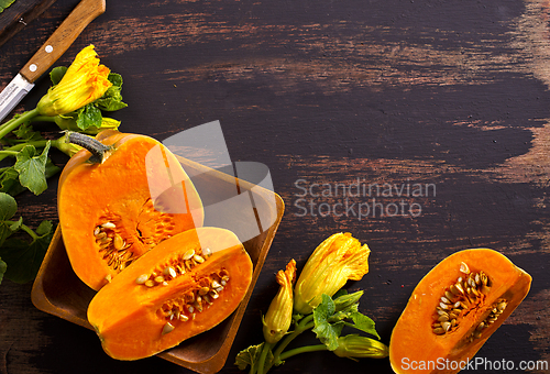 Image of fresh pumpkin on wooden table, raw pumpkin