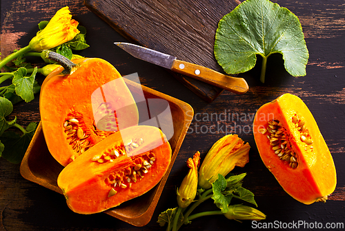 Image of fresh pumpkin on wooden table, raw pumpkin