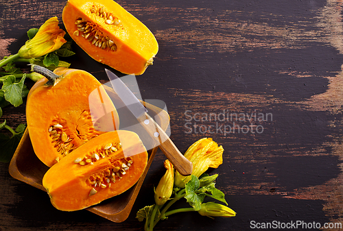 Image of fresh pumpkin on wooden table, raw pumpkin