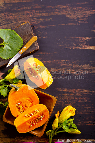 Image of fresh pumpkin on wooden table, raw pumpkin