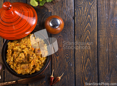Image of Uzbek cuisine food pilaf, rice with carrots, vegetable oil, raisins