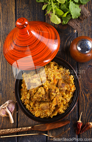 Image of Uzbek cuisine food pilaf, rice with carrots, vegetable oil, raisins