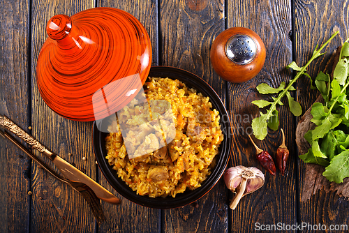 Image of Uzbek cuisine food pilaf, rice with carrots, vegetable oil, raisins