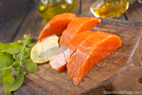 Image of raw salmon with fresh lemon and salt