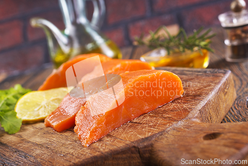 Image of raw salmon with fresh lemon and salt