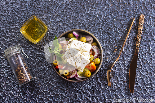 Image of Greek salad of fresh juicy vegetables, feta cheese, herbs and olives