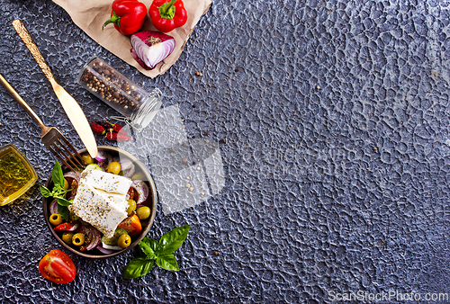 Image of Greek salad of fresh juicy vegetables, feta cheese, herbs and olives