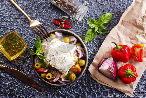 Image of Greek salad of fresh juicy vegetables, feta cheese, herbs and olives
