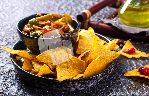 Image of Nachos with guacamole and vegetables.