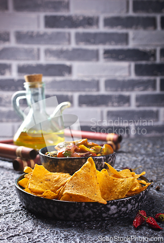 Image of Nachos with guacamole and vegetables.