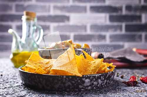 Image of Nachos with guacamole and vegetables.