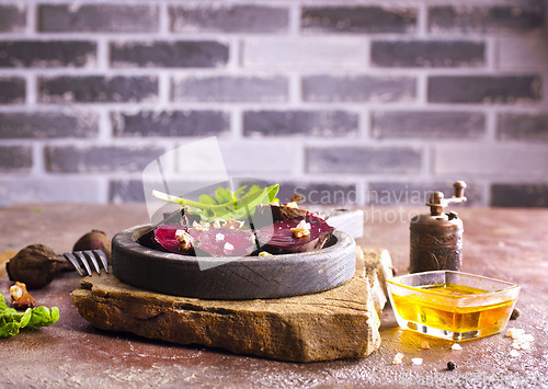 Image of Fresh sliced beetroot salad with nuts and parsley