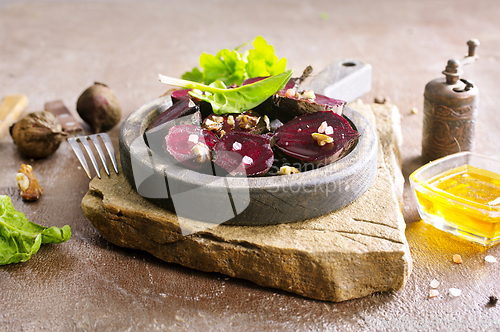 Image of Fresh sliced beetroot salad with nuts and parsley