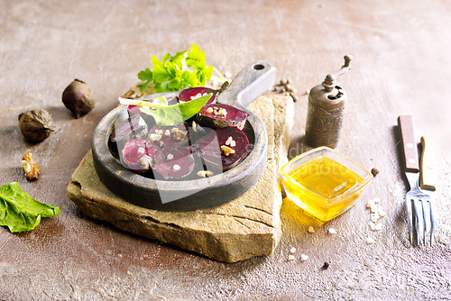 Image of Fresh sliced beetroot salad with nuts and parsley