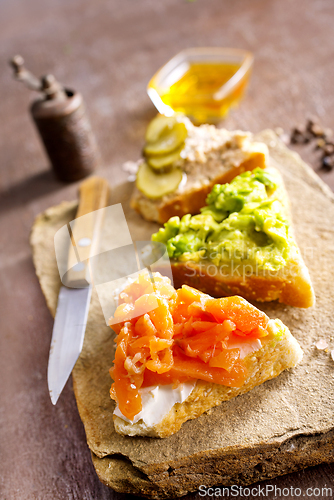 Image of Open sandviches with guacamole, fish and tuna