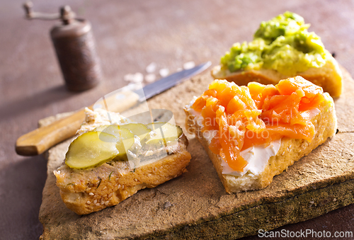 Image of Open sandviches with guacamole, fish and tuna