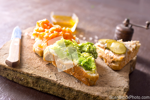 Image of Open sandviches with guacamole, fish and tuna