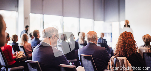 Image of Woman giving presentation on business conference event.