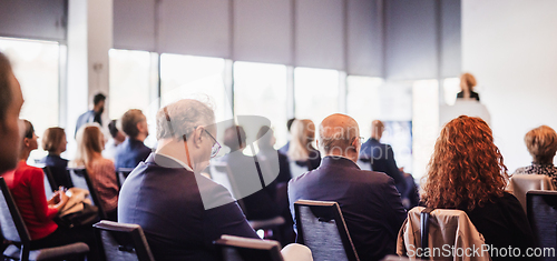 Image of Woman giving presentation on business conference event.