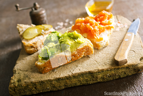 Image of Open sandviches with guacamole, fish and tuna