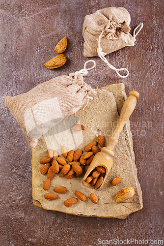 Image of Almond on stone background, dry almond