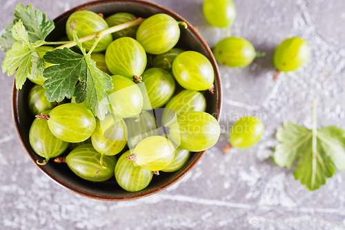 Image of fresh organic gooseberries in a wooden bowl