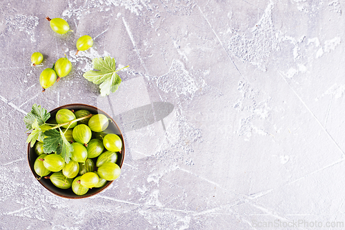 Image of fresh organic gooseberries in a wooden bowl