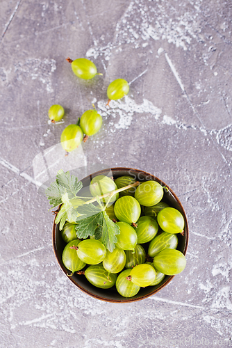 Image of fresh organic gooseberries in a wooden bowl