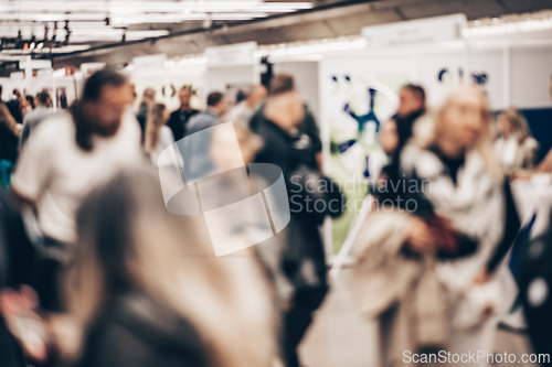 Image of Abstract blurred people at exhibition hall of expo event trade show. Business convention show or job fair. Business concept background.