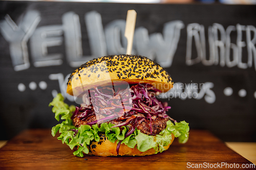 Image of Fresh colorful vegan burgers with vegetables on counter at summer local food market - close up view. Outdoor cooking, gastronomy, vegetarian, street food concept.
