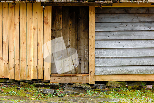 Image of Wooden cabin entrance with rustic design in a serene natural set
