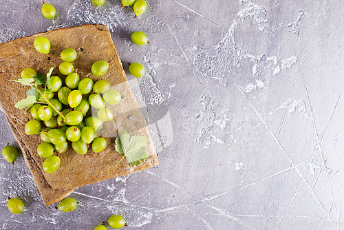 Image of fresh organic gooseberries in a wooden bowl