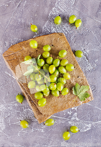 Image of fresh organic gooseberries in a wooden bowl