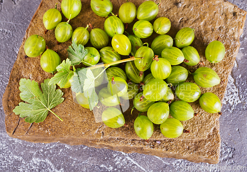 Image of fresh organic gooseberries in a wooden bowl
