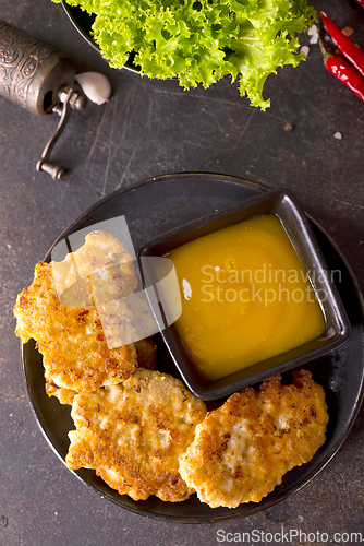 Image of Roasted chicken cutlets on black plate