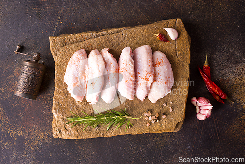 Image of Raw chicken wings with ingredients for cooking