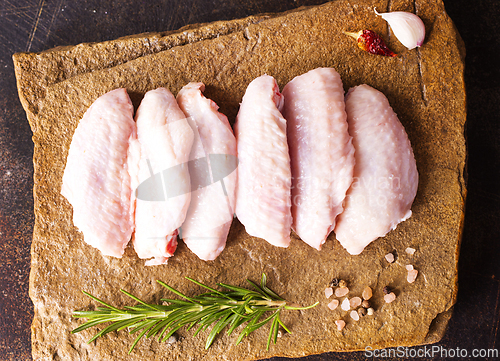 Image of Raw chicken wings with ingredients for cooking