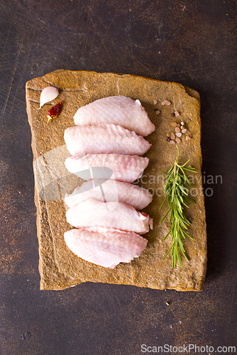 Image of Raw chicken wings with ingredients for cooking