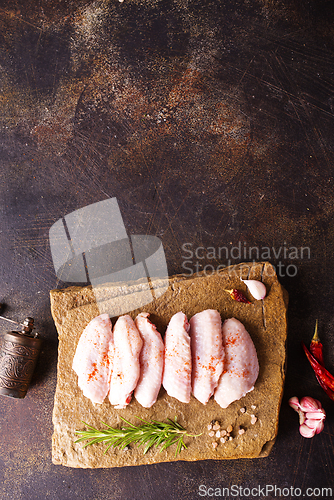 Image of Raw chicken wings with ingredients for cooking